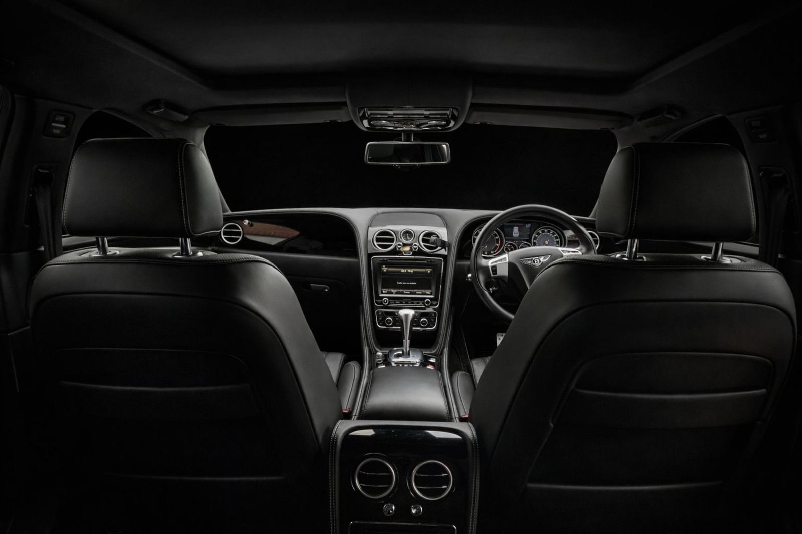 Wedding Chauffeur Service Manchester interior of a black Bentley luxury saloon with premium leather seating arranged by MCR EXEC for wedding transport