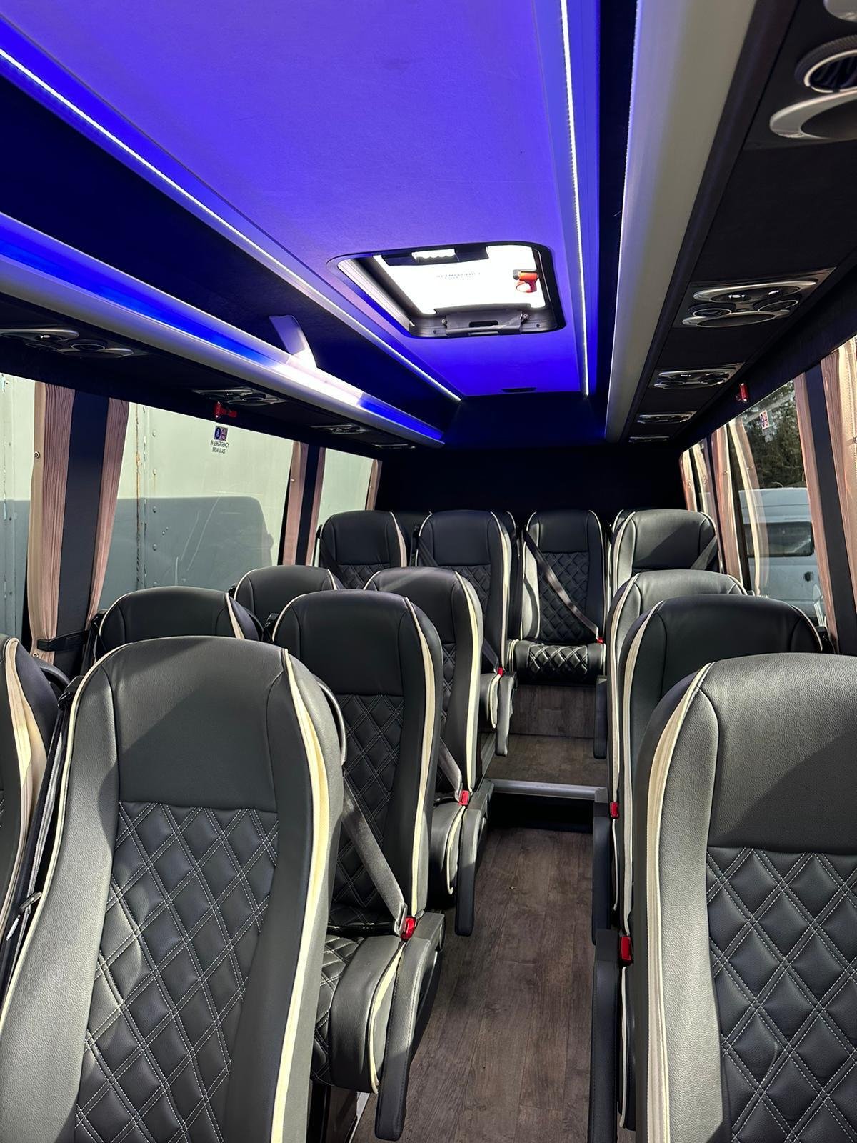 Luxury wedding guest transport interior with leather seating and ambient lighting by MCR EXEC
