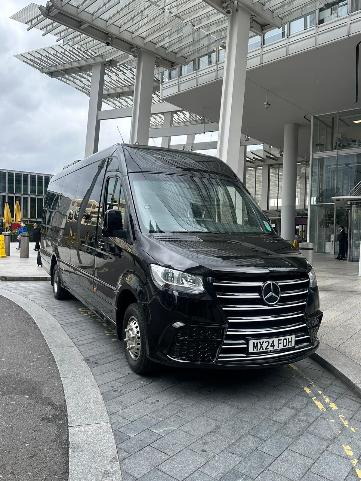 Black Mercedes luxury wedding guest transport vehicle used for coordinated wedding chauffeur logistics