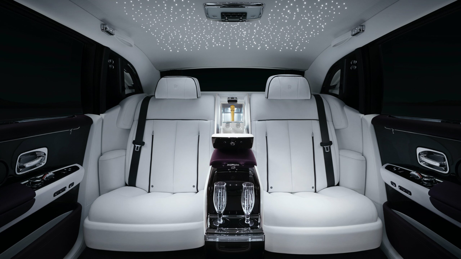 Luxury Rolls-Royce Cullinan interior with champagne display and starlight roof for wedding chauffeur service