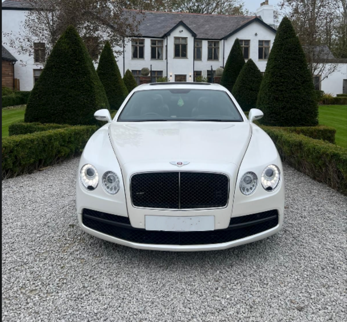 Wedding Chauffeur Service Manchester white Bentley Flying Spur luxury wedding car arriving at a countryside wedding venue arranged by MCR EXEC