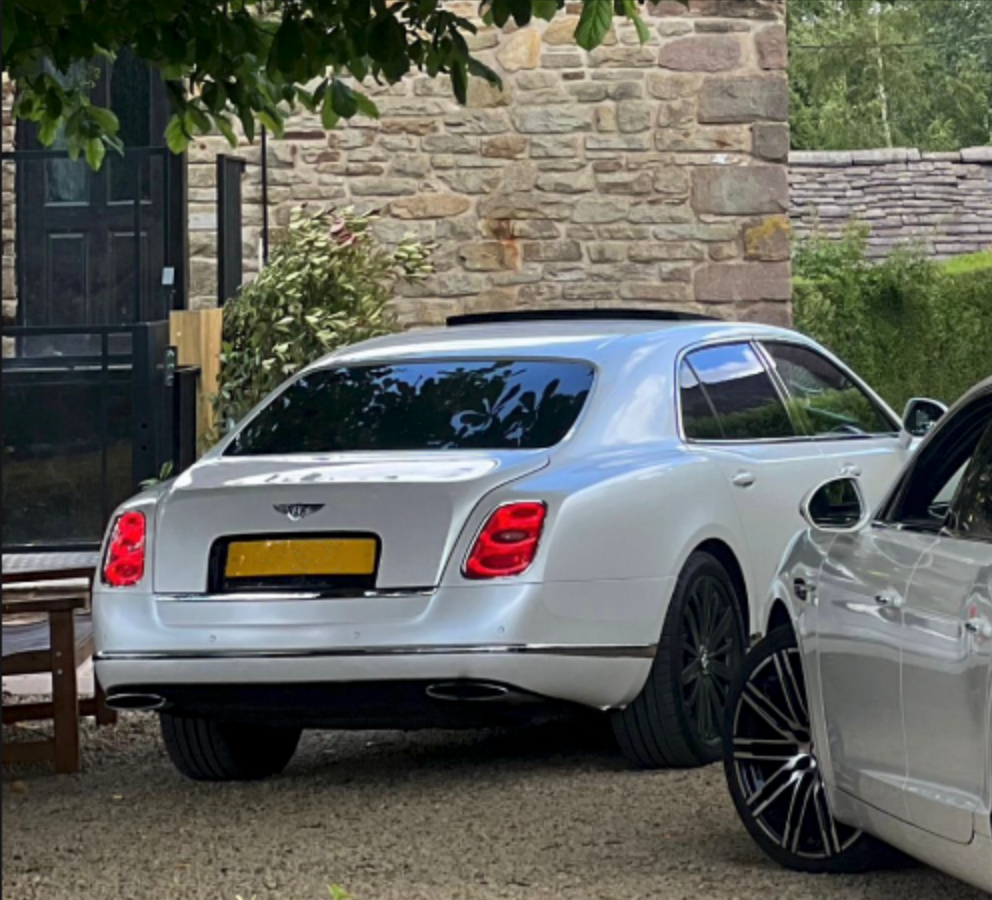 Wedding Chauffeur Service Manchester white Bentley Mulsanne luxury wedding car with MCR-EXEC number plate arriving at a countryside wedding venue