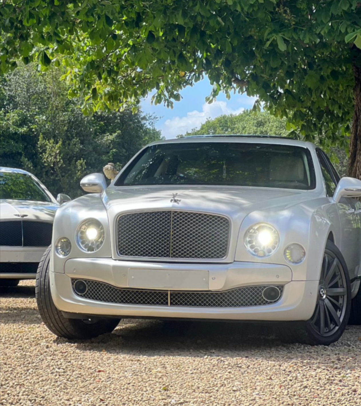 Wedding Chauffeur Service Manchester white Bentley Mulsanne luxury wedding car with MCR EXEC partner vehicle arriving at a countryside wedding venue