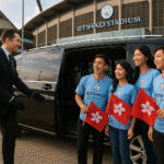 Chauffeur opening MPV door for Hong Kong Manchester City fans holding Hong Kong flags at Etihad Stadium