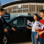 Chauffeur opening luxury car door for South Korean supporters holding South Korea flags at Etihad Stadium