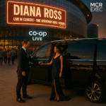 MCR EXEC Chauffeur opens door for elegantly dressed woman arriving at Co-op Live for Diana Ross concert in a black Mercedes-Benz at golden hour
