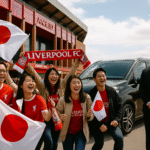 Japanese Liverpool FC fans arriving at Anfield with MCR EXEC chauffeur service, luxury Mercedes MPV, Japanese flags, joyful match day atmosphere.
