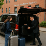 Chauffeur assisting a student with luggage outside student housing at Liverpool John Moores University before departure to Manchester Airport