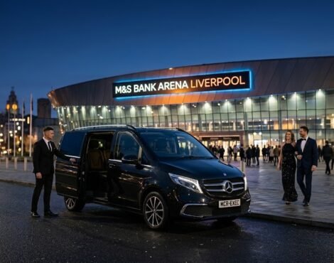 M&S Bank Arena Chauffeur Service with black 2025 Mercedes V-Class MPV by MCR EXEC parked outside M&S Bank Arena Liverpool at night with chauffeur opening door for event guests