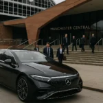 Luxury Mercedes chauffeur vehicle outside Manchester Central Convention Complex for corporate and event arrivals.