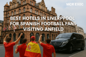 Spanish football fans arriving in Liverpool for Champions League at Anfield, standing near The Shankly Hotel with a luxury Mercedes V-Class chauffeur vehicle and MCR EXEC branding.