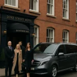 MCR EXEC chauffeur with Mercedes V-Class outside Duke Street Boutique Hotel Liverpool, assisting stylish passengers preparing for Manchester Airport transfer.