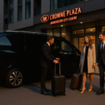Ultra HD image of MCR-EXEC chauffeur with Mercedes V-Class outside Crowne Plaza Manchester City Centre, assisting travellers with luggage. Executive transfers for business and leisure guests.