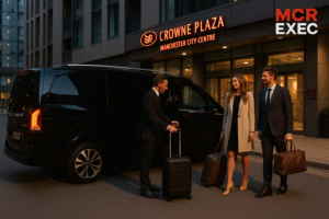 Ultra HD image of MCR-EXEC chauffeur with Mercedes V-Class outside Crowne Plaza Manchester City Centre, assisting travellers with luggage. Executive transfers for business and leisure guests.