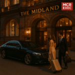 Ultra HD image of MCR-EXEC chauffeur with Mercedes S-Class outside The Midland Hotel Manchester, assisting luxury travellers with luggage. Exclusive executive transfer to Manchester’s five-star hotels.