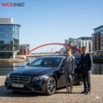 Black Mercedes E-Class with MCR-EXEC number plate parked at The Lowry Theatre, Salford Quays, Manchester, representing MCR EXEC’s executive chauffeur services.