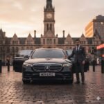 Luxury Executive Travel Tameside – black Mercedes S-Class chauffeur vehicle by MCR EXEC outside Ashton Town Hall at sunset.