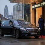 Chauffeur service for hospitality guests with a black Mercedes S-Class arriving at a luxury city hotel, professional MCR-EXEC chauffeur opening the door for VIP hotel guests during evening check-in
