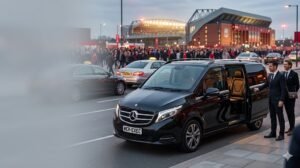 Liverpool vs PSG chauffeur service with a black Mercedes V-Class by MCR EXEC arriving near Anfield for a Champions League match night in Liverpool