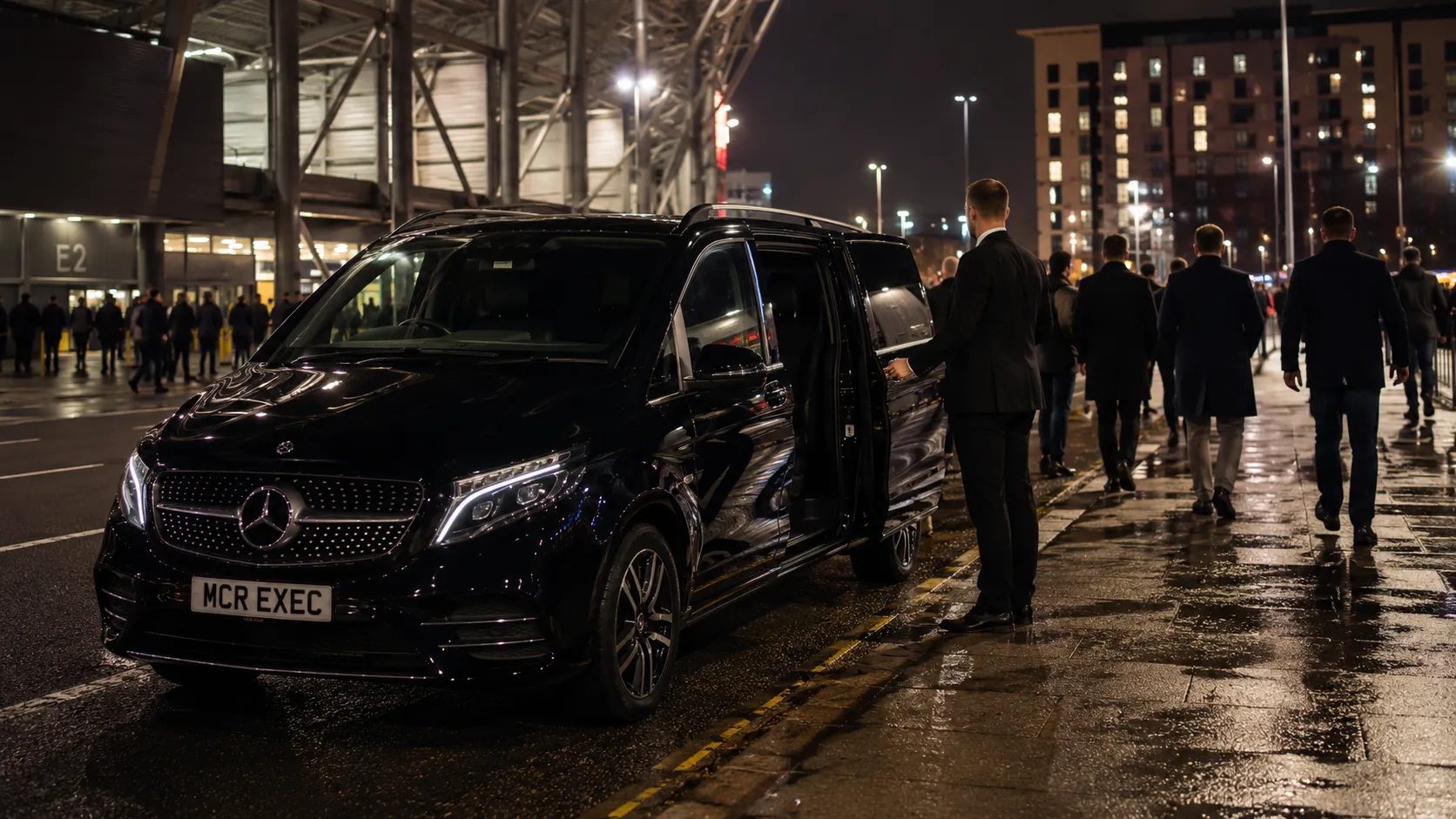 Football Chauffeur Hire Manchester with a black Mercedes-Benz V-Class by MCR EXEC waiting near a stadium for post-match chauffeur collection
