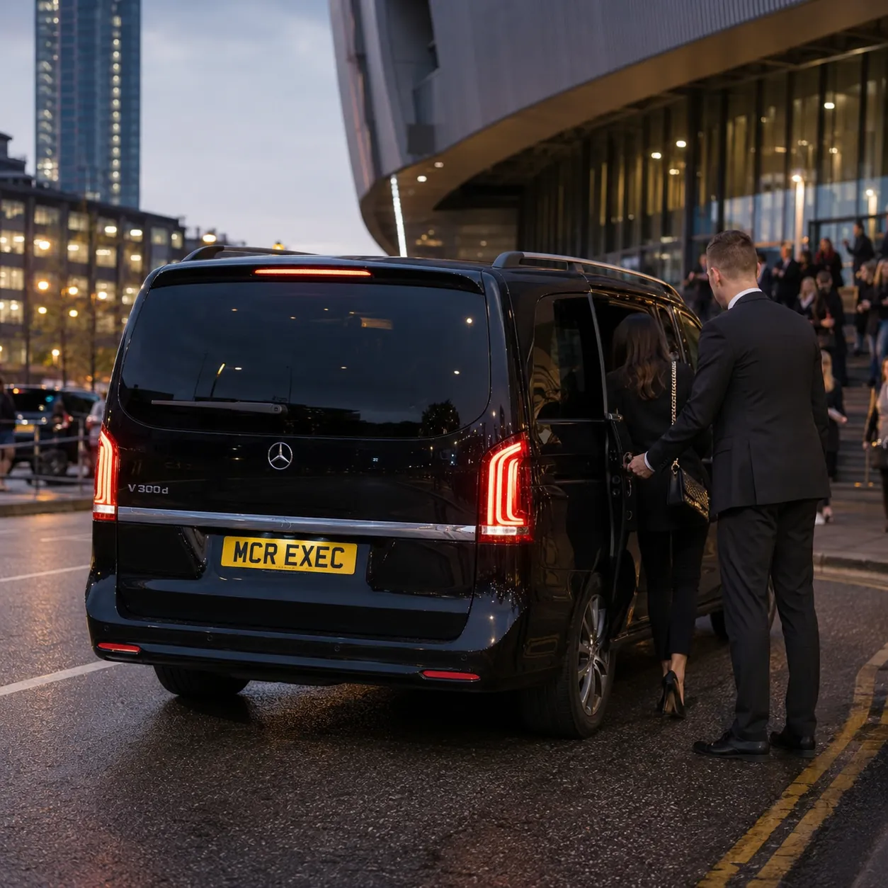 Half-Day Chauffeur Service Manchester with black Mercedes-Benz V-Class by MCR EXEC arriving near a Manchester arena-style venue for concert and music event travel