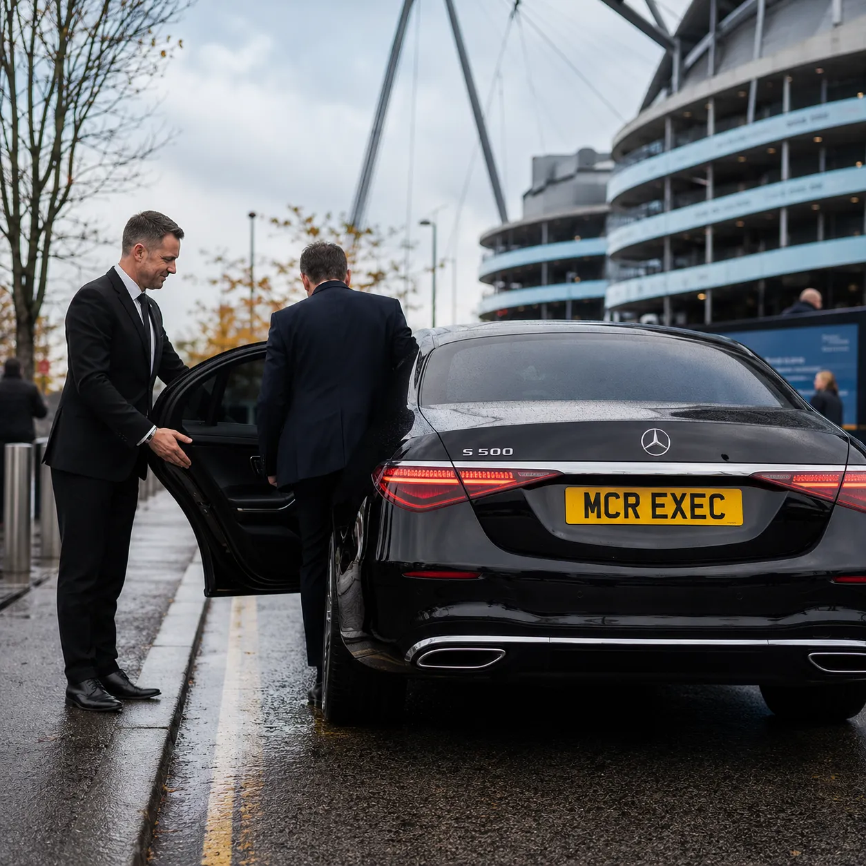 Half-Day Chauffeur Service Manchester with black Mercedes-Benz S-Class by MCR EXEC near a Manchester stadium for football hospitality and sporting event travel