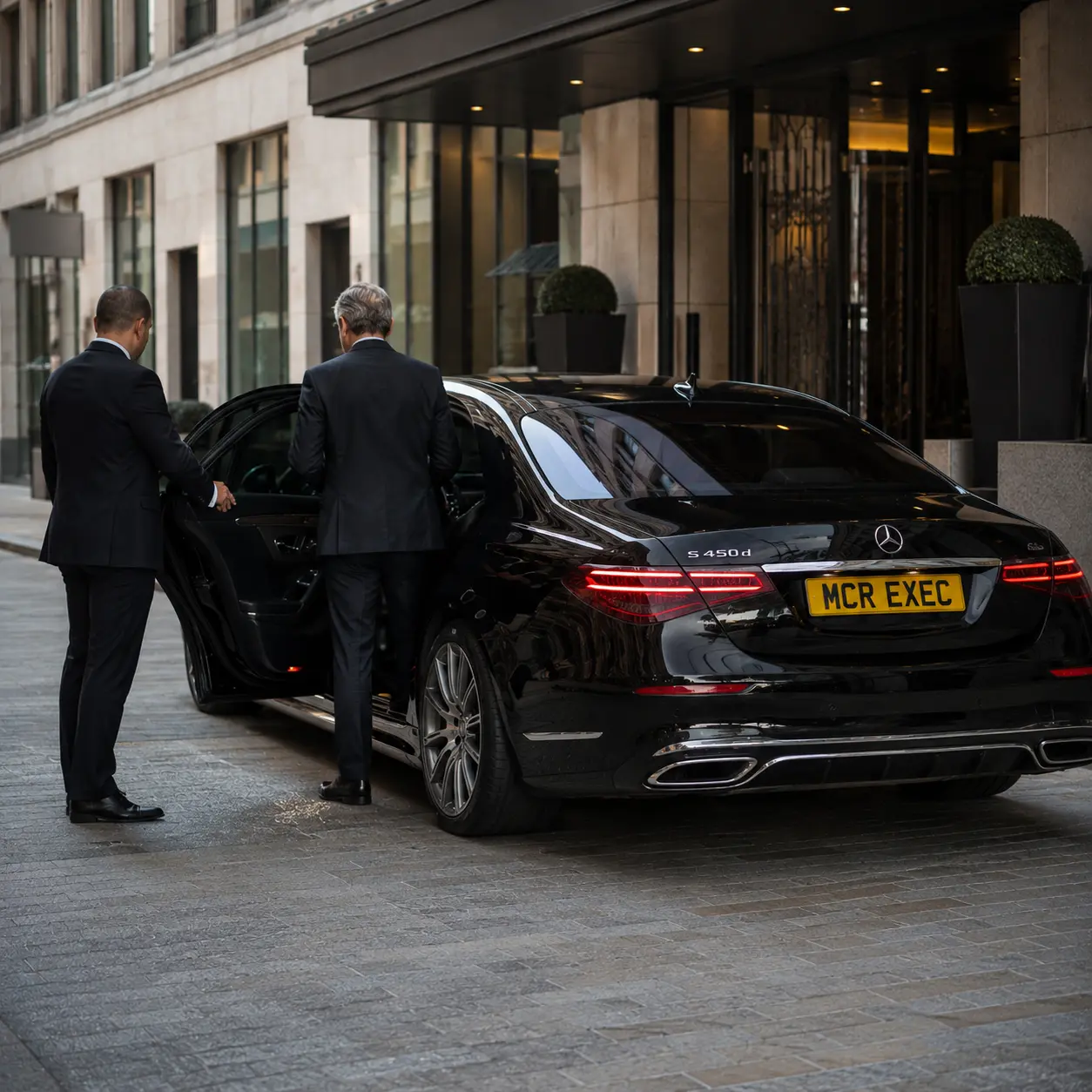Full-Day Chauffeur Hire Manchester for VIP hotel guests with a black Mercedes S-Class by MCR EXEC outside a luxury hotel