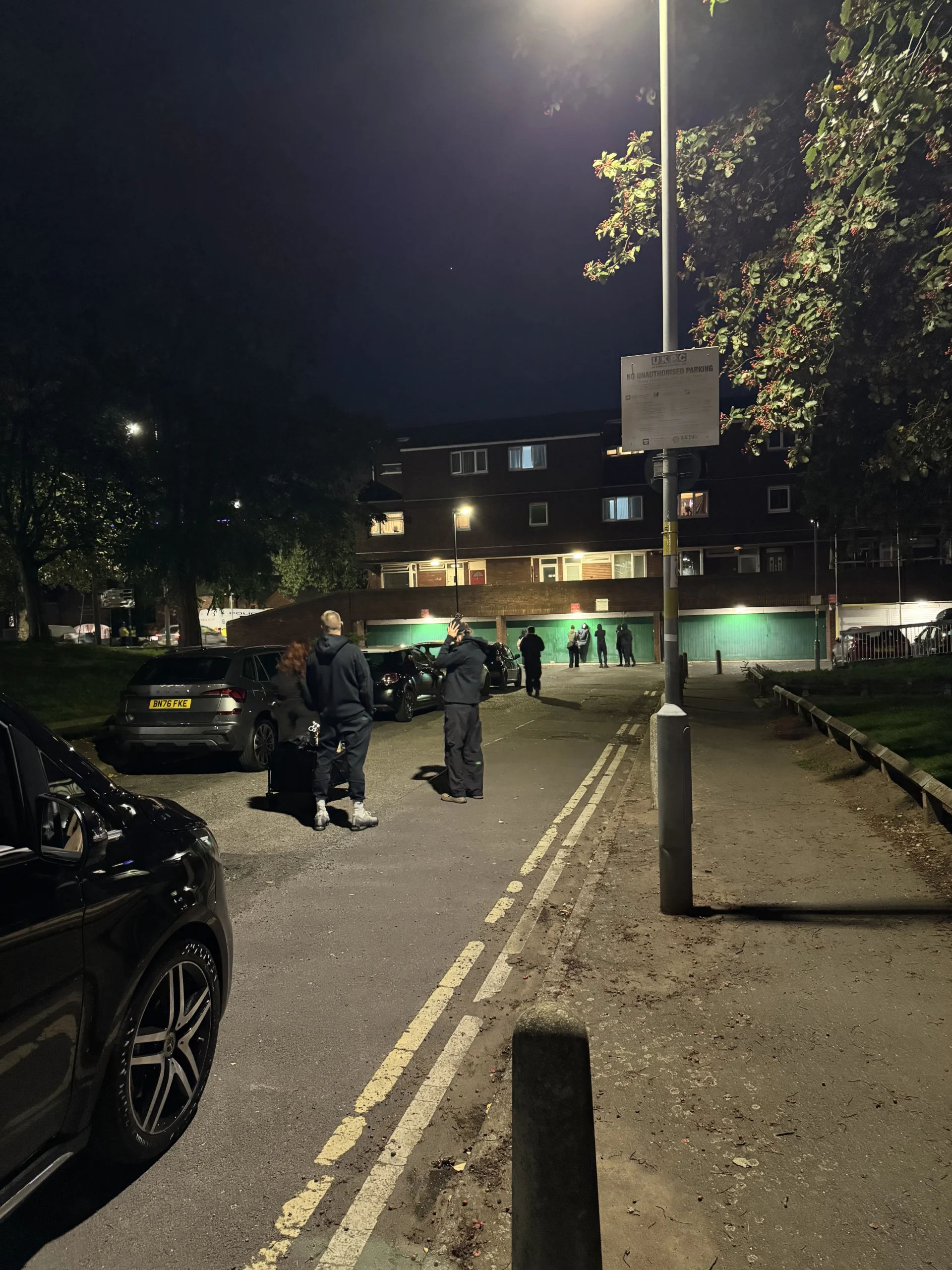 Production activity on a residential street after dark during the Birmingham shoot