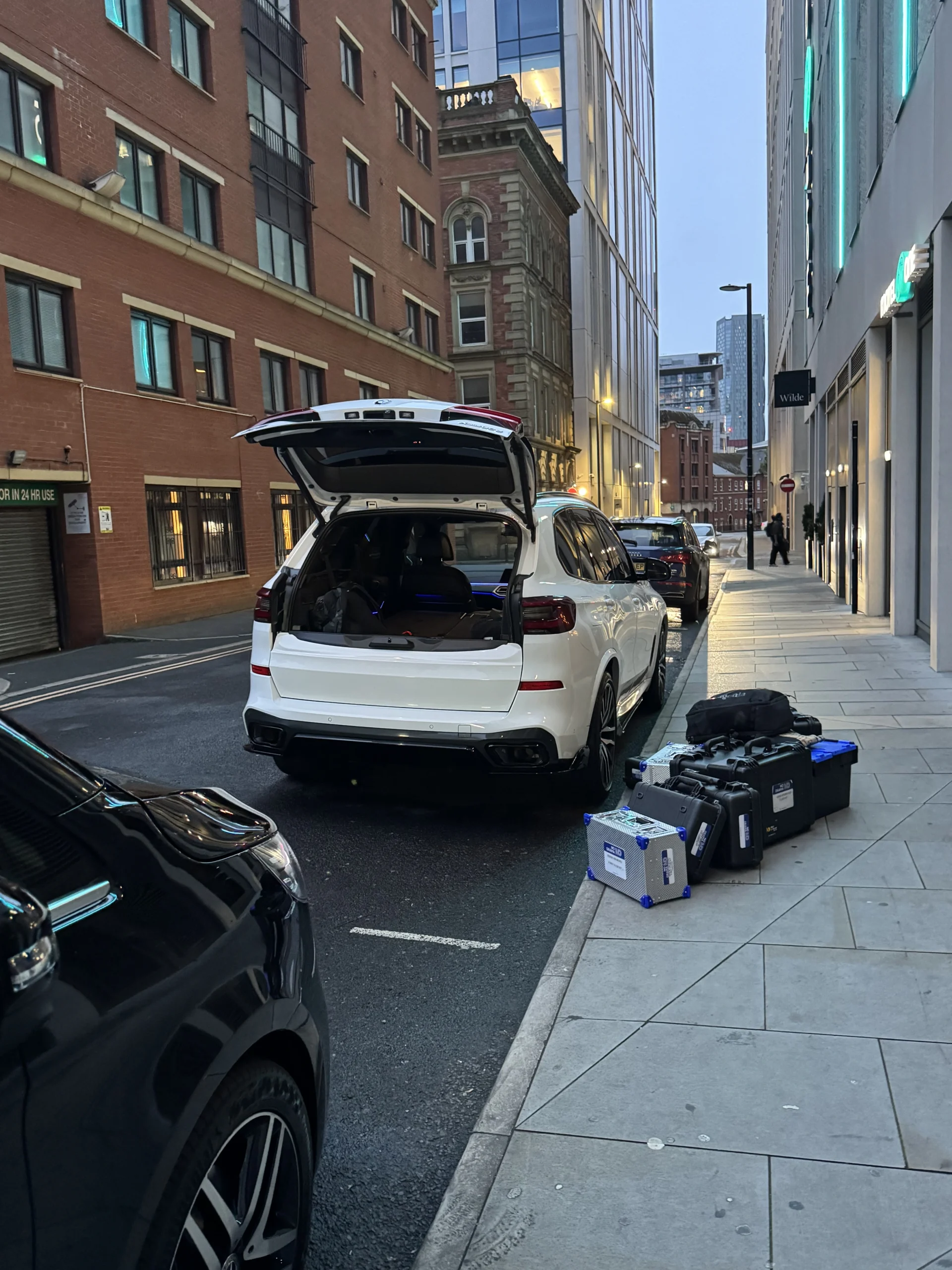 Production equipment cases beside a separate white production vehicle during the Manchester collection
